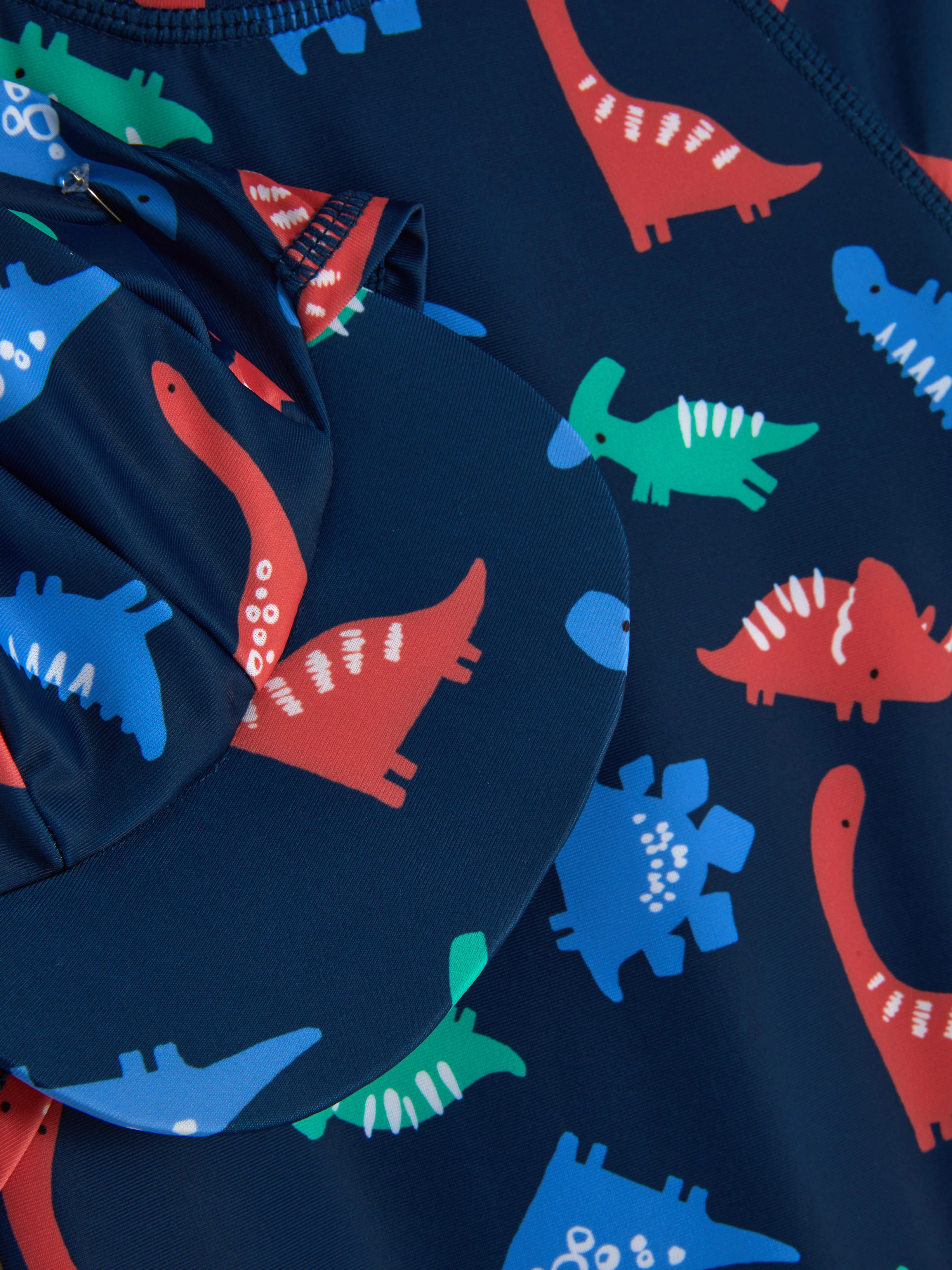 Set de gorro y bañador estampados con dinosaurios
